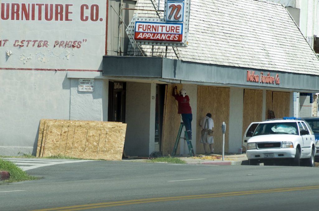 Commercial storefront boarded up after damage
