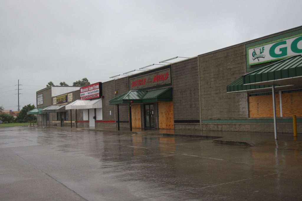 Commercial storefront boarded up after damage